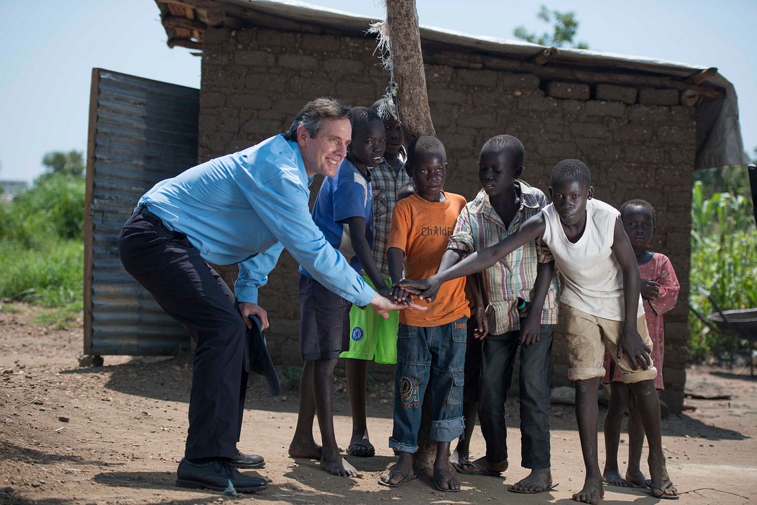 President and CEO of CRS, Sean Callahan making friends with the local children of Bidi Bidi, one of the largest refugee settlements in the world. Photo by Hugh Rutherford for Catholic Relief Services